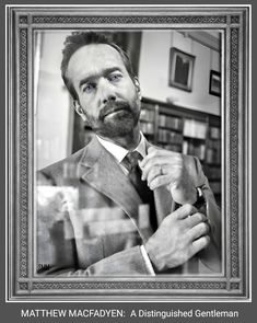 a black and white photo of a man adjusting his tie