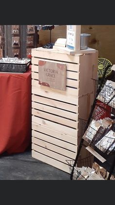 a wooden crate with a sign that says victoria's grace on it and some baskets next to it