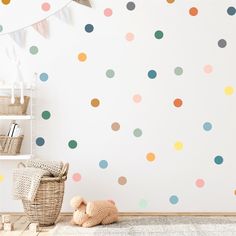 a child's room with polka dot wall decals on the walls and a teddy bear