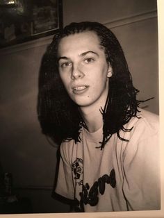 an old photo of a woman with long hair