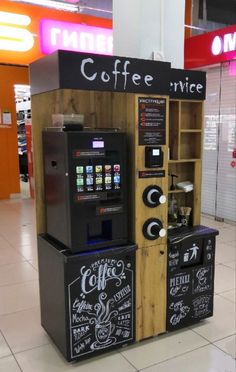 the coffee vending machine is made out of wood and has chalk writing on it