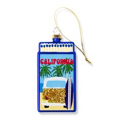 a bottle shaped ornament with a surfboard on the beach and palm trees in the background