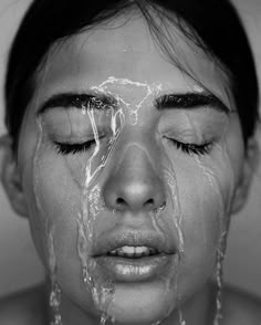 a woman with her face covered in water