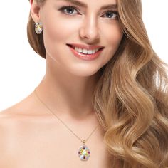 A celebration of artistry and color. Finely crafted from sterling silver, finished in 18k yellow gold, this ornate ensemble is a testament to your timeless style. An intricate arrangement of colorful gemstones, each chosen for its unique charm creates a charming focal point. An opulent Opal sits at the heart, surrounded by radiant Rhodolites, warm Citrines, refreshing Peridots and serene Blue Topaz. The dynamic interplay of hues creates a mesmerizing kaleidoscope that captures attention and sparks conversation. Embrace the enchantment of this collection and let your style speak volumes with every step. Exquisite Multicolor Oval Jewelry, Fine Jewelry With Oval Jeweled Details, Oval Jeweled Fine Jewelry, Fine Jewelry With Jeweled Oval Details, Fine Jewelry Multicolor Gift, Multicolor Fine Jewelry For Gift, Exquisite Multicolor Jewelry For Anniversary, Multicolor Fine Jewelry As Gift, Elegant Multi-stone Oval Pendant Jewelry