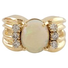 an opal and diamond ring in yellow gold