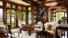 a living room filled with furniture and lots of windows