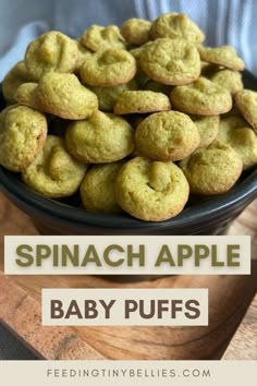 spinach apple baby puffs in a black bowl on a wooden cutting board with text overlay