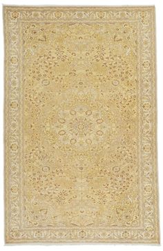 an antique rug with gold and cream colors