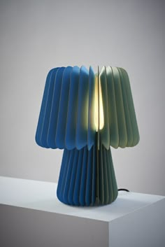 a blue lamp sitting on top of a white table