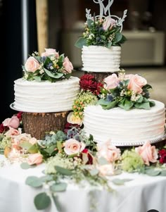 three tiered wedding cake with flowers and greenery