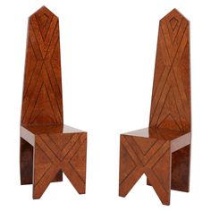 two wooden chairs sitting next to each other