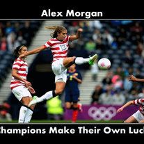 alex morgan is kicking a soccer ball in front of two other women on the field