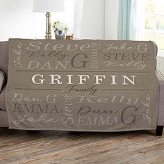 a living room with a couch covered in a blanket that says griffin family on it