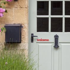 a white door with the name ciao bella on it and some pink flowers