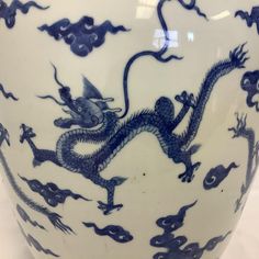 a blue and white vase with a dragon on it