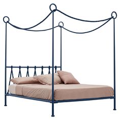 a metal bed frame with an iron headboard and foot board