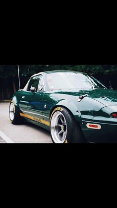 a green sports car parked in a parking lot