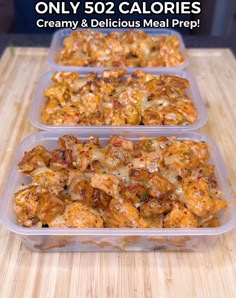 three plastic containers filled with food sitting on top of a wooden table