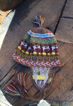 a knitted hat sitting on top of a wooden table