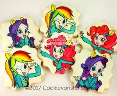 four decorated cookies with cartoon characters on the top one is white and has pink hair