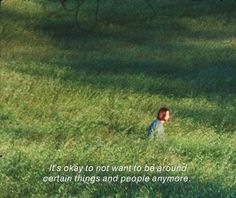 a little boy sitting in the middle of a field with a quote on it that says, it's okay to not want to be around certain things and people anymore