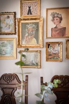 there are many framed pictures on the wall with flowers in vase next to each other