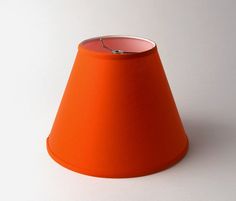 an orange lamp shade on a white background