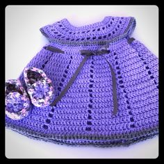 a purple crocheted dress and booties are shown