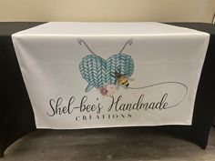 a table with a sign that says shel - bee's handmade creations