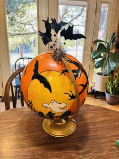 a pumpkin decorated with halloween decorations on top of a table