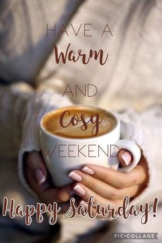 a woman holding a cup of coffee with the words have a warm and cosy weekend happy saturday