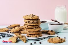 a stack of cookies sitting on top of a table next to a glass of milk