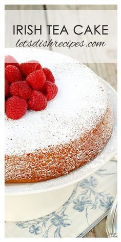 a cake topped with raspberries on top of a white plate