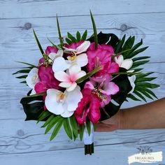 a person holding a bouquet of pink and white flowers