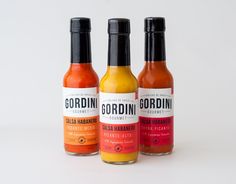 three bottles of gordini hot sauce on a white background