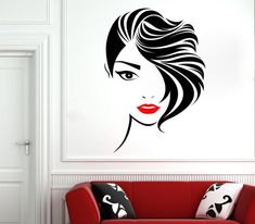 a woman's face with red lips and black hair is shown on the wall