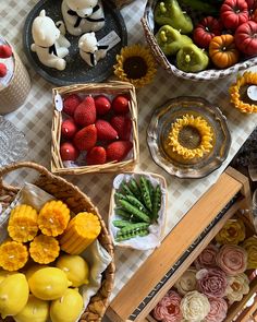 several baskets filled with fruit on top of a table next to other plates and bowls