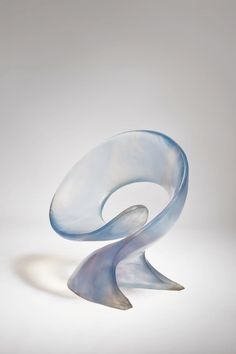 a glass sculpture sitting on top of a white table