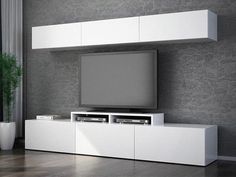 a white entertainment center with a flat screen tv mounted on it's sideboard