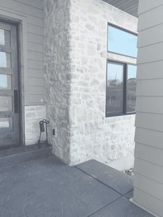 an empty front porch with a door and window