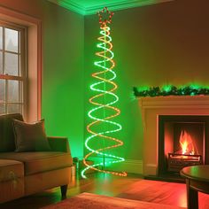 a living room with a lit christmas tree in the corner and a fire place next to it