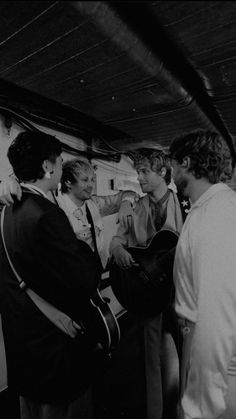 black and white photograph of men playing guitars