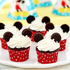 mickey mouse cupcakes with white frosting on a plate