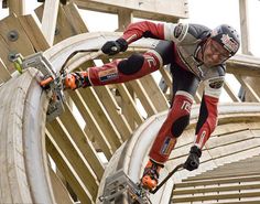 a man riding skis down the side of a wooden ramp