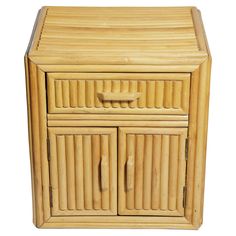 a wooden cabinet with two doors and drawers on the front, made out of bamboo