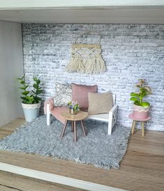 a miniature living room with couches, tables and potted plants on the floor