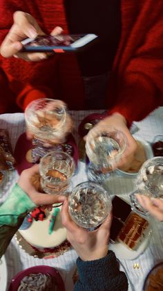 several people sitting at a table holding wine glasses