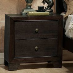 a night stand with two drawers and a lamp on top