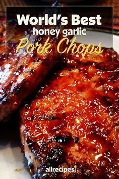 grilled pork chops with bbq sauce on the side and title world's best honey garlic pork chops