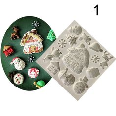 an assortment of christmas cookie molds on a green plate